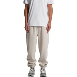 Relax Track Pants in a light cream colour, featuring a loose fit and an elastic waistband, paired with a plain white t-shirt.