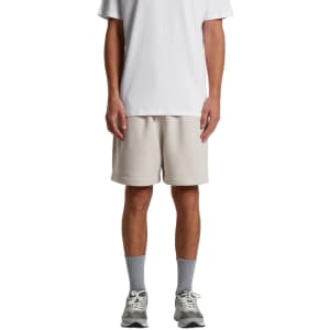 Relax Track Shorts in light beige, featuring an elastic waistband and a logo, paired with a plain white t-shirt.