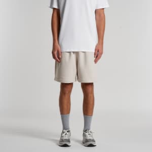 Relax Track Shorts in light beige, featuring a relaxed fit, worn with a white t-shirt and grey socks.