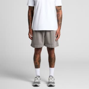 Relaxed grey track shorts with a casual fit, featuring an elastic waistband and a logo. Pair styled with a white T-shirt.