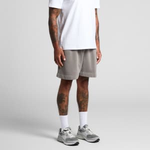 Faded grey track shorts with an elastic waistband, modelled by a person wearing a white T-shirt and trainers.
