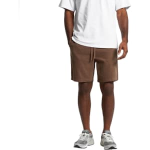 Cord shorts in a rich brown colour, featuring an elastic waistband and side pockets, paired with athletic shoes.