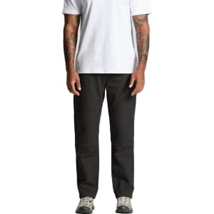 A person wearing black cargo pants, standing straight, with arms at their sides, in a plain white t-shirt and shoes.