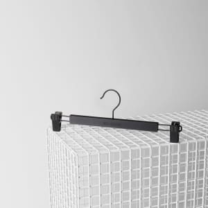 A black clip hanger designed for holding items, featuring adjustable clips and a hook for hanging.