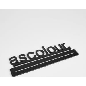 A black promotional product with the word 'ascolour' and a rectangular base, featuring a logo design.