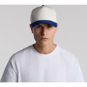A two-tone cap featuring a cream front and blue peak, worn by a model in a white t-shirt.