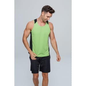 A man wearing a green and black singlet with black shorts, smiling while looking down. The singlet has a logo.