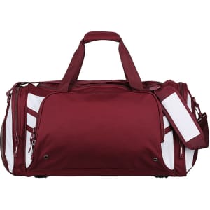 A maroon duffle bag with white accents, featuring multiple compartments and a handheld strap, plus a detachable strap.
