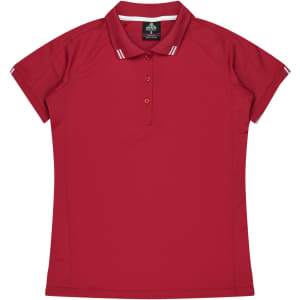 A red polo shirt with short sleeves and a collar, featuring a branded label and contrasting stripes.