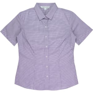 A short sleeve, button-up shirt in a purple and white check pattern, featuring a collar and a logo.