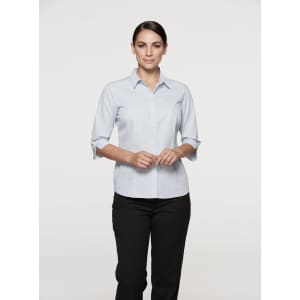 A button-up shirt in light blue with 3/4 sleeves, featuring a subtle stripe pattern and a logo.