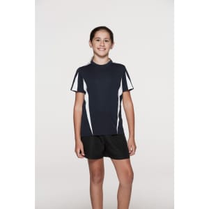 A girl in a navy blue T-shirt with white stripes, paired with black shorts, standing against a plain background.