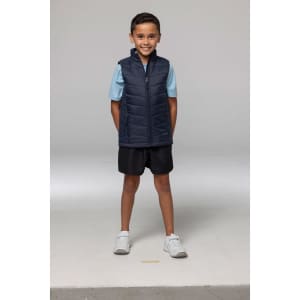 A navy blue vest with a zippered front, displayed on a child wearing a light blue shirt and black shorts.