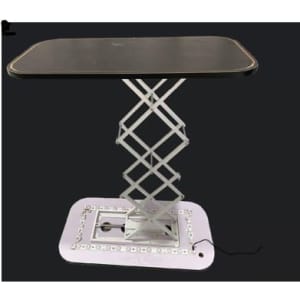 A hydraulic counter with a black rectangular top and a silver scissor lift base, featuring a light-up platform.