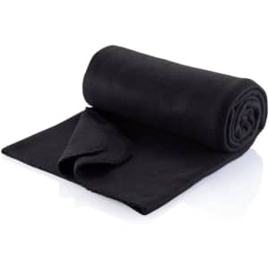 A black polar fleece travel rug, rolled and partially unfolded, showcasing a soft texture and stitched edges.
