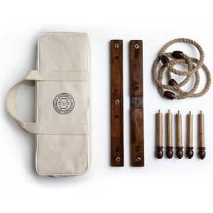 A Backyard Quoits Set featuring wooden quoits, ropes, and scoring boards in a cream carry case.