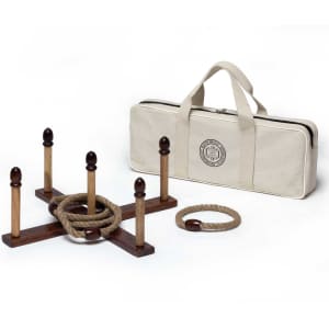 A wooden backyard quoits set with a canvas carry bag, featuring brown pegs and a rope ring.