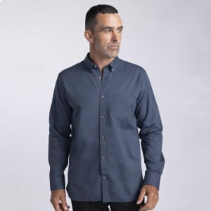 A men's button-up shirt in navy blue with a chest pocket and a branding logo, featuring a classic collar.