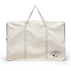 A large cream carrying bag with handles, featuring a logo related to a cornhole set.