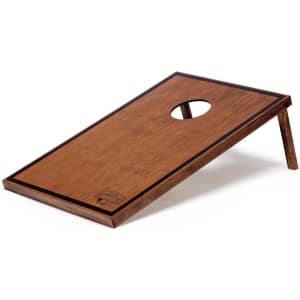 A wooden cornhole board with a polished finish and a circular hole, featuring a sturdy folding leg design.