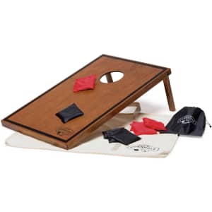 A wooden cornhole board with a hole, black and red bags, and a carrying bag featuring a logo.