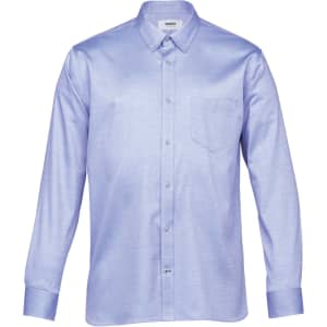 A light blue button-up shirt with long sleeves and a chest pocket, featuring a logo.