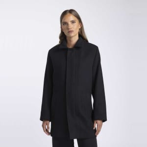 A wool jacket in black with a simple collar and side pockets, featuring a branding logo.