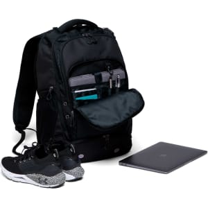 A black backpack displays multiple compartments, including one for a laptop, alongside a pair of shoes and a laptop.