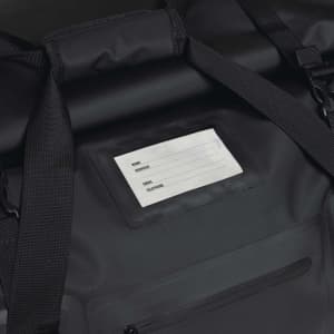 A black duffle bag with adjustable straps and a clear identification panel. The bag has a pocket with a zipper.