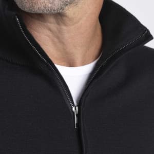 A close-up of a black Merino zip-up shirt for men, featuring a high collar and a visible zipper.