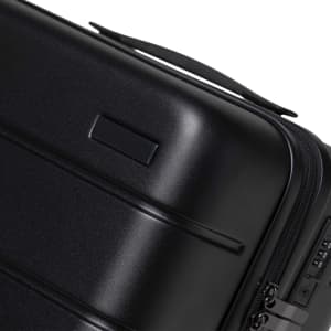 A black hardcase trolley with a smooth finish and a handle, featuring a zip closure and a small branding area.