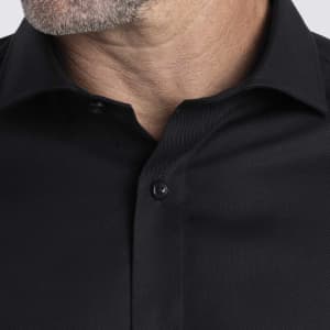 A black button-up shirt with a textured fabric and collar, featuring a logo on the design.