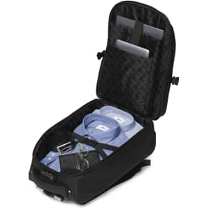 A black trolley backpack with a spacious interior, neatly organised with shirts, accessories, and compartments for devices.