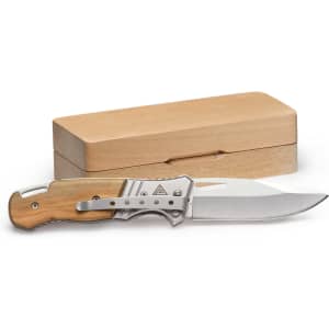 A pocket knife with a wooden handle and a silver blade is displayed alongside a wooden box.