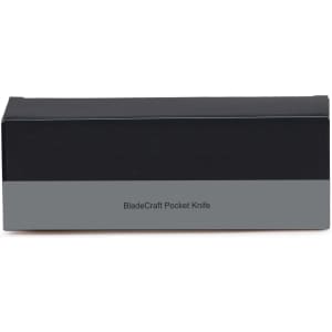 A black and grey box featuring a pocket knife product. It includes a logo but no visible text or images of the knife.