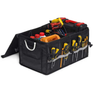 A black organiser featuring multiple compartments, holding tools, bottles, and a cordless drill.