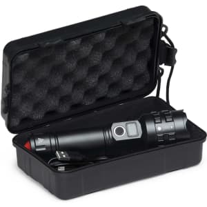 A black torch in a plastic case, featuring a charging cable and a textured interior. The torch has a silver button and detailing.