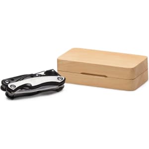 A multi-tool featuring a sleek black design, presented in a wooden box.