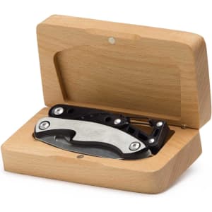 A black multi-tool is housed in a wooden box, showcasing its sleek design and metallic components.