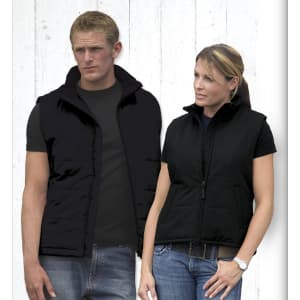 A black men's vest displayed on a male model alongside a black women's vest on a female model. Both have a zippered front and pockets.