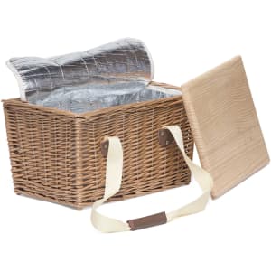 A brown wicker picnic basket with a silver insulated interior and a removable wooden lid.