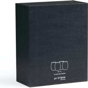 A black box containing a set of four Festive Wine Glasses, featuring a minimalist design. The box has a logo.