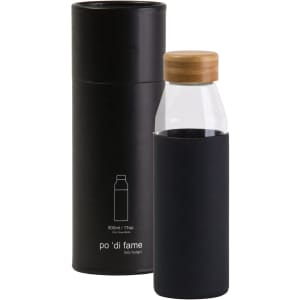 A drink bottle with a clear body, black silicone sleeve, and bamboo lid, presented in a cylindrical black container.
