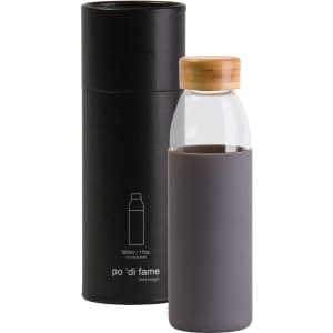 A drink bottle with a clear glass body, grey silicone sleeve, and wooden lid, presented in a black cylindrical packaging with a logo.