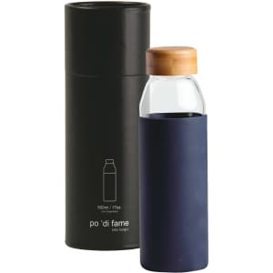 A drink bottle with a clear glass body, navy silicone sleeve, and bamboo lid, presented in a black cylindrical box.