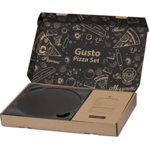 A pizza baking set in a cardboard box featuring a black pizza stone and branded packaging with food illustrations.