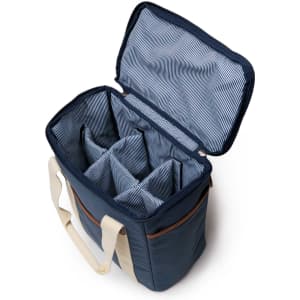 A wine cooler with a navy exterior and a striped interior, featuring several compartments and a carry handle.