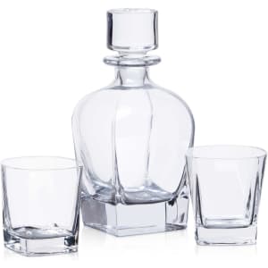 A drink bottle and two matching glasses in clear glass, featuring a classic design with a stopper.
