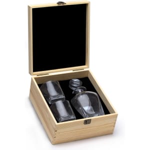A drink bottle and two glasses in a wooden box with a black velvet interior. The set is clear glass.