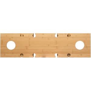 A rectangular bamboo table surface with circular cutouts, featuring a smooth finish in light brown tones.